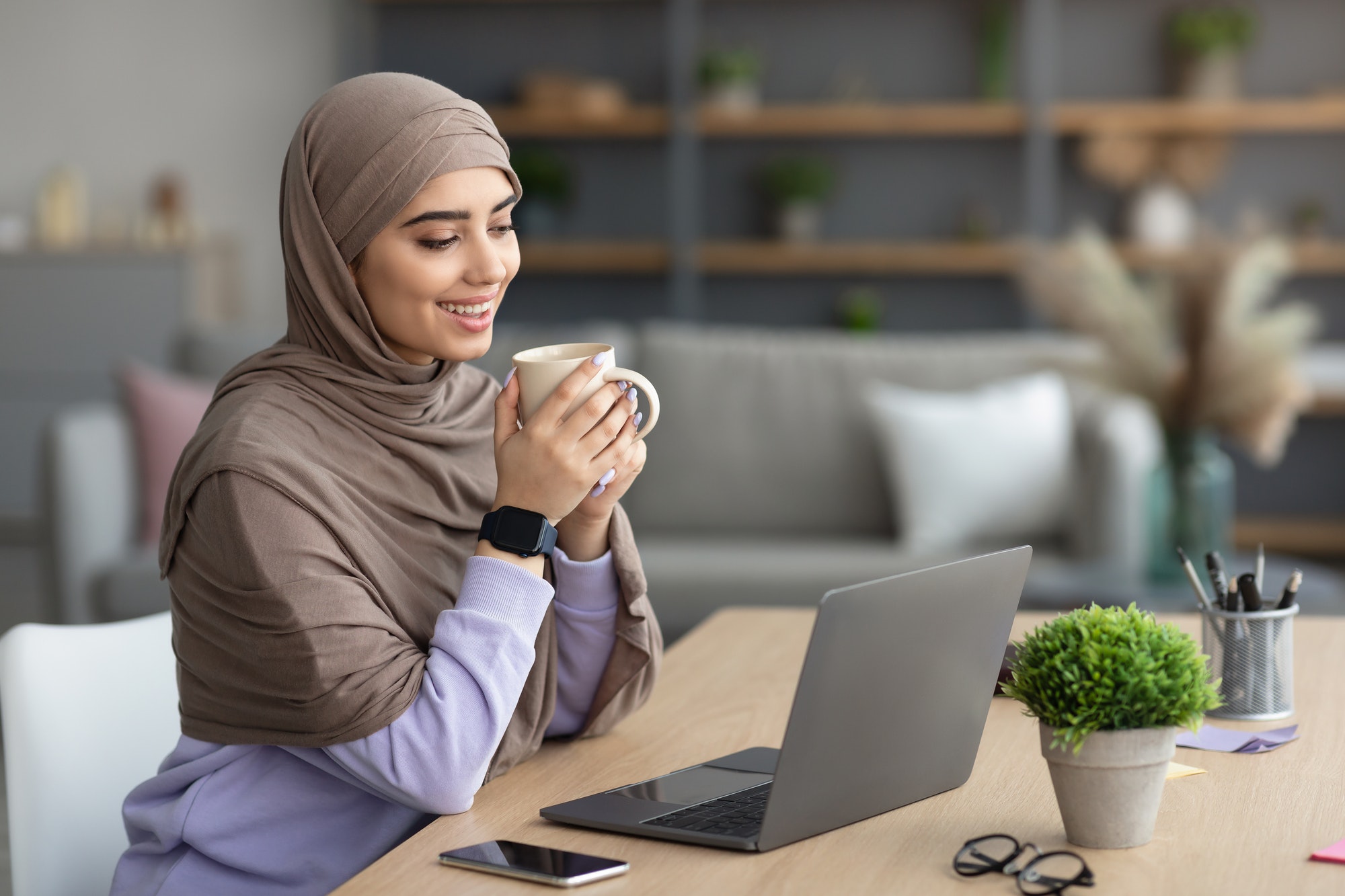 muslim woman watching video on computer